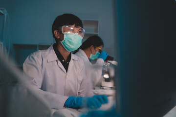 2 scientists are analyzing data eco skin care beauty products in nighttime laboratory development...