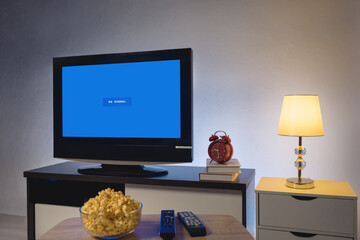 4K LCD television with blue screen no signal, on cabinet in the living room at home, interior...