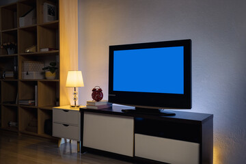 Modern 4K LCD television with blue screen on cabinet in the living room at home, interior design, cut out screen