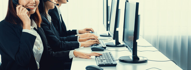 Business people wearing headset working in office to support remote customer or colleague. Call...