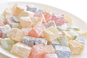 Turkish delight or lokum on a white plate.