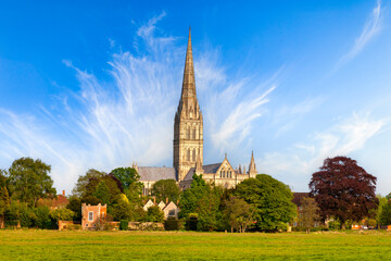 Salisbury Cathedral, believed by many to be the most beautiful building in England, on a fine spring day. It was built between 1310 and 1330, and has the tallest church spire in the UK. - obrazy, fototapety, plakaty
