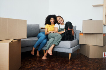 New home, portrait and lesbian couple with a dog on the sofa for moving boxes and relocation. Smile, lgbt and women or people on the living room couch of an apartment with a pet and a homeowner