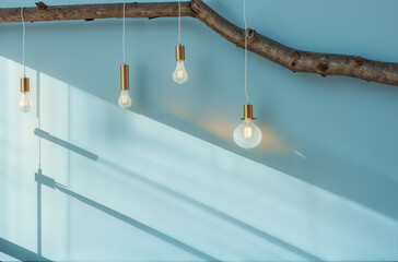 Fototapeta premium Illuminating Ambiance: Blue Wall adorned with Radiant Bulbs