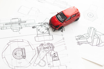small car model and blueprint sheets
