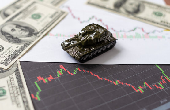 toy tank on the background of dollar bills.