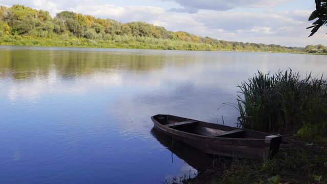 Wooden boat on the river bank