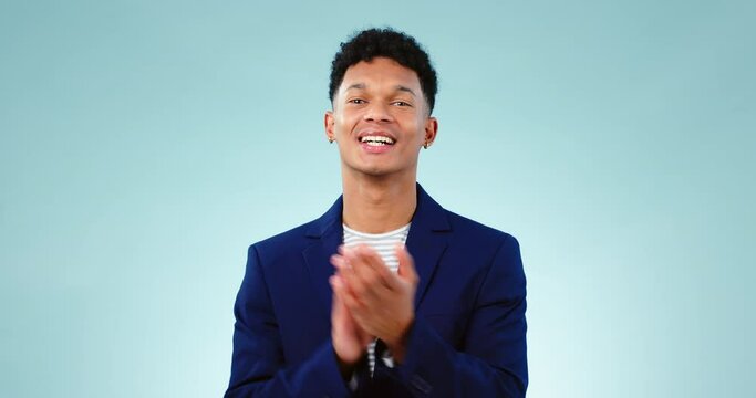 Face, clapping and congratulations of happy man in studio isolated on a blue background mockup space. Portrait, applause and person smile to celebrate achievement of goal, success and prize winner