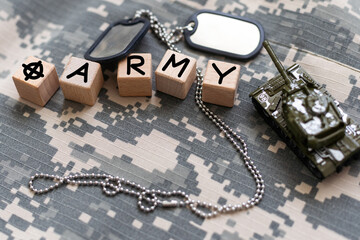 Military ID tags and patches on camouflage background
