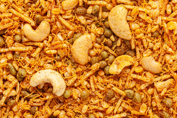 Indian spicy snacks (Namkeen), made with cashew nuts, roasted Moong Dal (Green Gram), and small besan sev. Full frame, wallpaper. Top view.