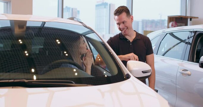 young woman asking to buy a vehicle, husband giving creadit card to her, family make decisiion to buy vehicle Sale Slow motion