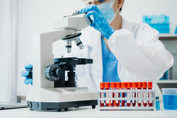 Modern medical research laboratory. female scientist working with micro pipettes analyzing biochemical samples, advanced science chemical laboratory