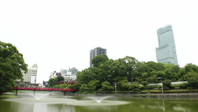OSAKA, JAPAN - JULY 2023 : View of Abeno Harukas building and Tennoji park at Abeno ward. Daytime time lapse shot. Travel and tourism concept video.