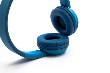 Blue wireless bluetooth headphones on white background. Music concept.
