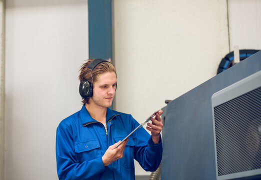 Man in headphones working on factory