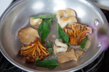 Foraged wild mushrooms sauté in a skillet