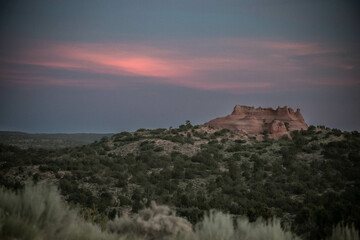 Red glow in the sky above a high desert landscape at dusk