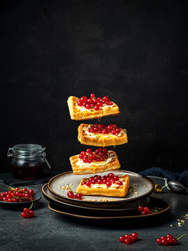 still life with sweet waffles on black table. Food levitation