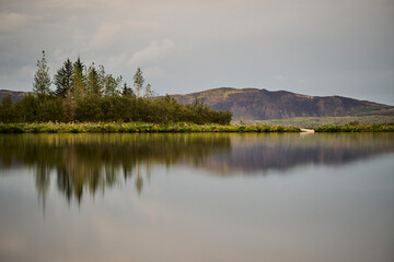 Mountains and trees on coast of serene lake