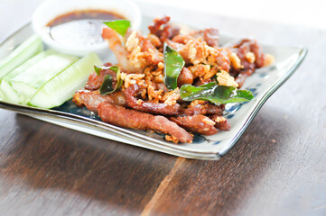 deep fried pork , belly of pork or pork or fried pork with cucumber and spicy sauce
