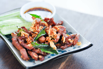 deep fried pork , belly of pork or pork or fried pork with cucumber and spicy sauce