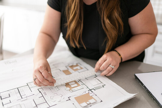 An interior designer measuring for a home renovation project