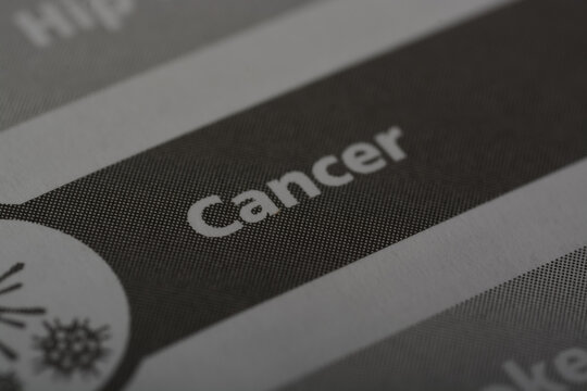 Close up view of the word CANCER. Cancer is a group of diseases characterized by the uncontrolled growth and spread of abnormal cells in the body.