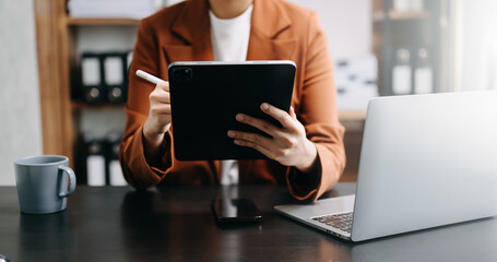 Bussinessman analyzing sales data and economic growth and pointing at business report document with graph chart financial chart marketing, banking and payments at modern office