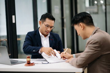 business people and lawyers discussing contract papers sitting at the table. Concepts of law, advice, legal services.