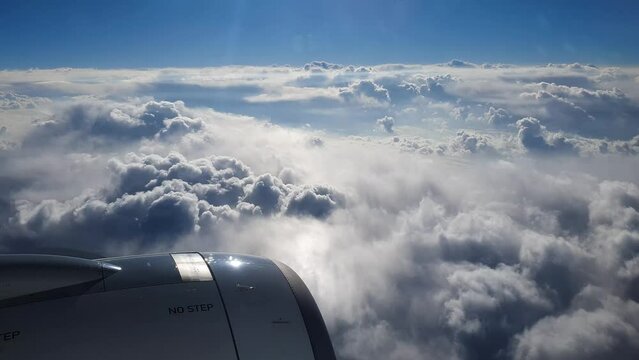Breathtaking view from plane's illuminator during morning flight. 4K video.