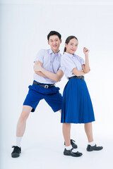 Thai students uniform. Asian girl and boy standing together friendly in students uniform on white background.