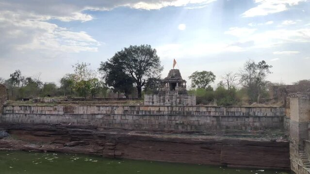 Footage of Chittorgarh Fort shot during daylight against blue sky and white clouds
