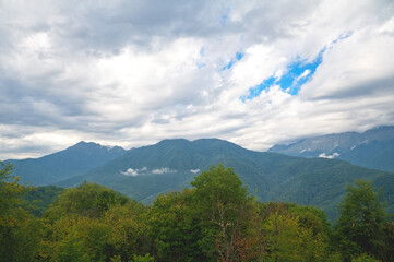 Beautiful view from the heights of mountains with clouds.
