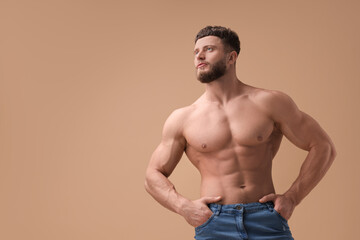 Fototapeta premium Handsome muscular man on beige background, space for text. Sexy body