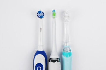 Electric toothbrushes on white background, flat lay