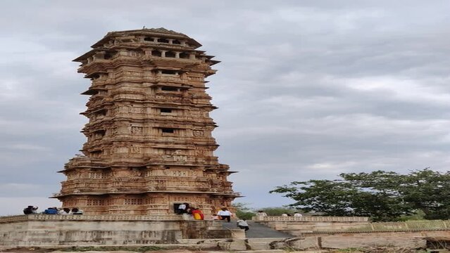 Time Lapse footage of Vijay Stambha at Chittorgarh Fort shot during daylight against blue sky and white clouds