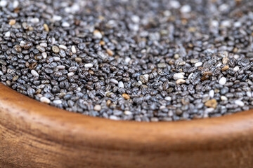 raw chia seeds rich in vitamins and minerals , wooden bowl