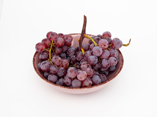 Red grapes on a white background. Ripe grapes close-up.