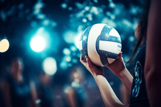 Women volleyball players hands blocking volleyball ball during match at night