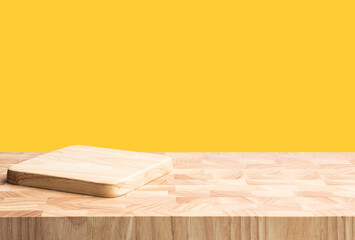 Chopping board on wood table with blur yellow background.For montage product display or design key visual