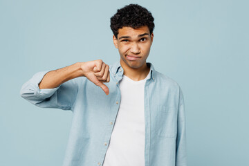 Young dissatisfied sad man of African American ethnicity wear shirt white t-shirt casual clothes...
