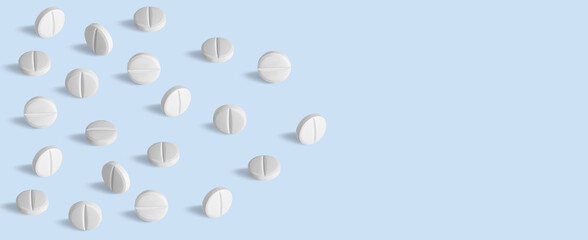 white capsules, pills and tablets. On.blue background.