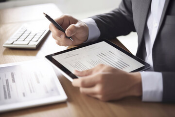 Close up of businessman hand holding pen and tablet with Financial charts. planning financial report, business plan, profit concept