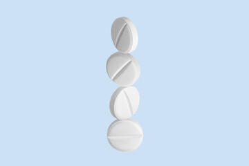 White capsules, pills and tablets flying up. On.blue background.