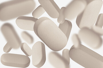 Natural beige herbal capsules, pills and tablets. On a light background.