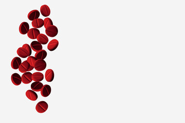 Red flying capsules, pills and tablets. On a light background.