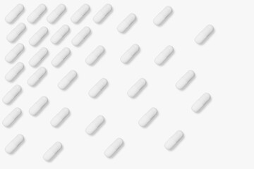 White tablets and pills. On a light background.