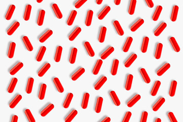Red pills and pills. On a light background.