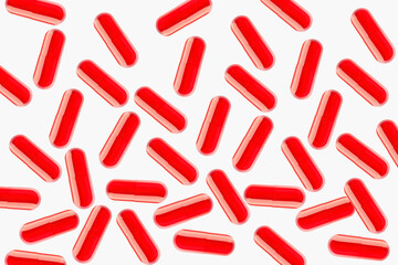 Red flying capsules, pills and tablets. On a light background.