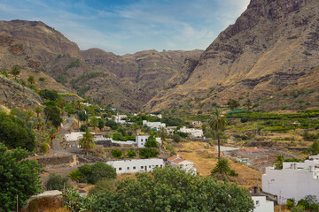 Fototapeta na wymiar The Agaete Valley (Gran Canaria) shows unique wild and rugged landscapes, with traditional houses and tropical fruit and coffee farms.